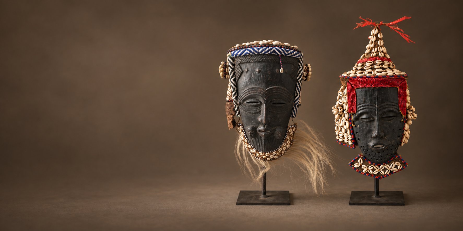 Pair of beaded African masks mounted on stands